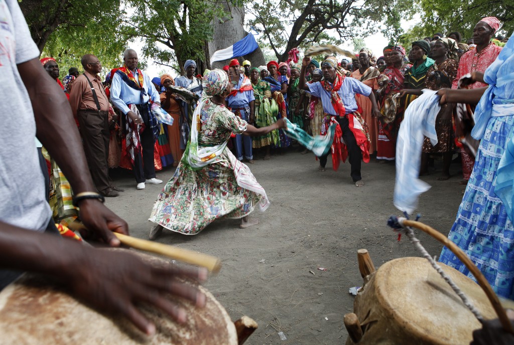 Haitians dance under a sacred ceibo tree called Lisa as they participate in a Voodoo ritual on the third day of the annual week-long gathering in the Souvenance community, April 1, 2013. Hundreds of Haitians participate in the ceremonies which begin the Saturday before Easter in Souvenance, where descendants of the people of Dahomey, a former kingdom in what is now present-day Benin, show their devotion to their ancestors and various lwa, or spirits, This third day of ceremonies represents their journey back to Africa. Picture taken April 1, 2013. REUTERS/Marie Arago (HAITI - Tags: SOCIETY RELIGION)